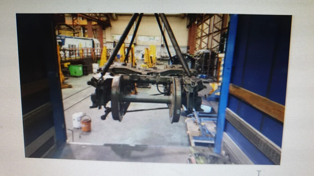 Chasis de tren suspendido en taller de mantenimiento industrial.